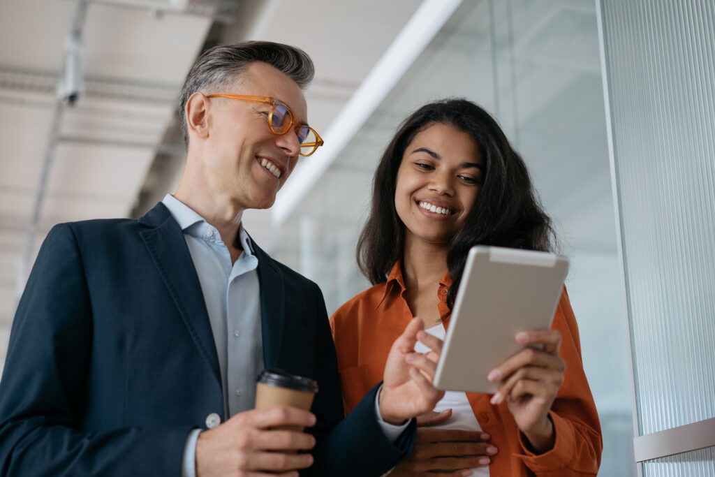 National insurance increase Business people using digital tablet planning start up project, sharing ideas at workplace. Successful colleagues working in modern office. Business meeting concept