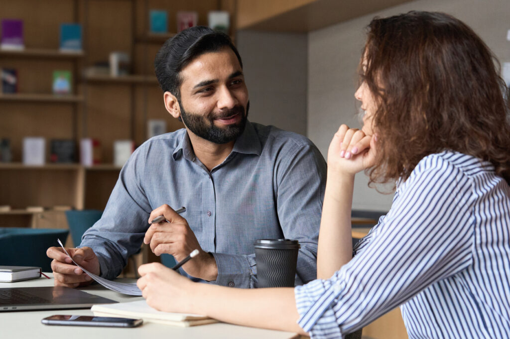 decorative. Employee wellbeing at work. two coworkers talk happily